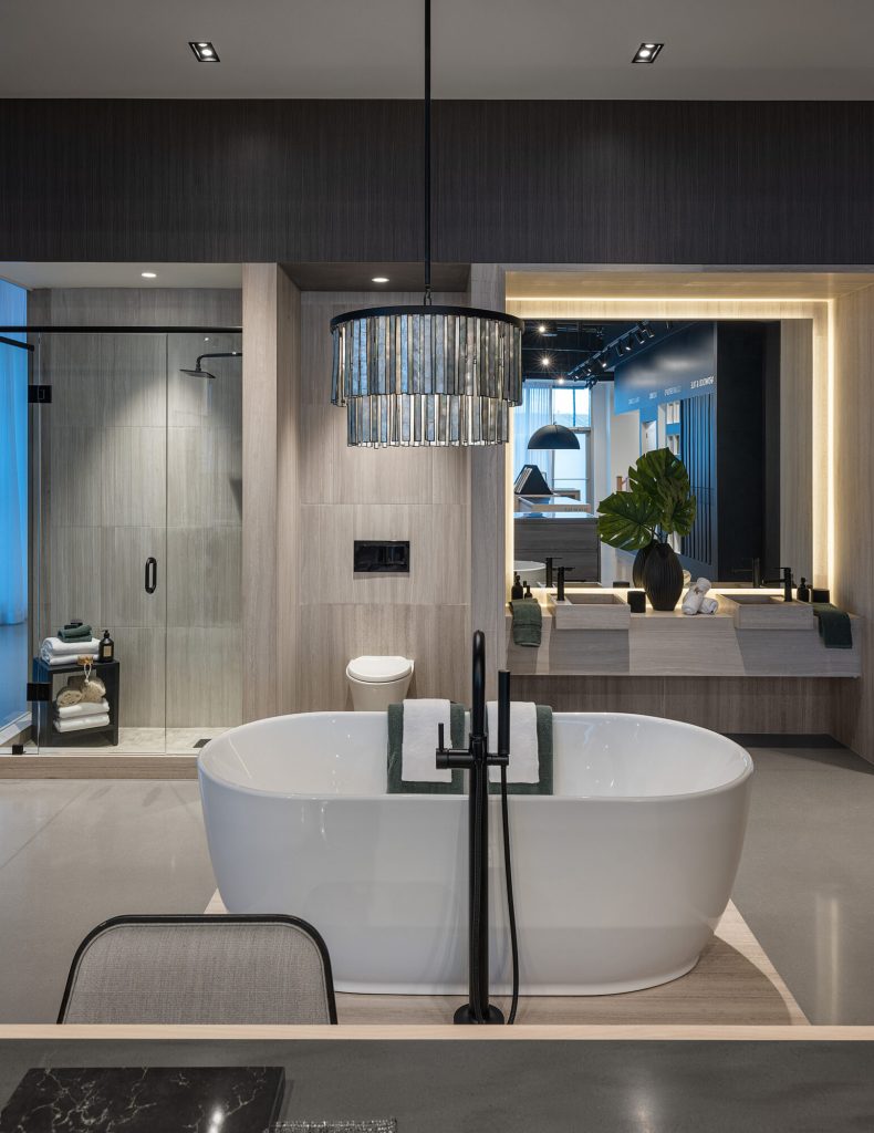 Bathroom vignette with a floating vanity and a backlit mirror