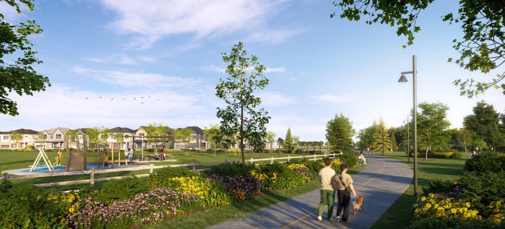 A paved pathway edged with wildflowers leads past a children’s playground and a row of homes on a clear summer day, with two people and a dog walking ahead.